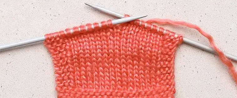 knitting with pink yarn