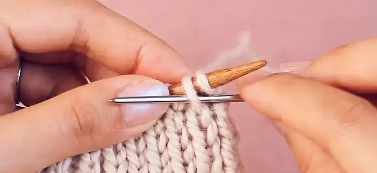 hands knitting a bind off