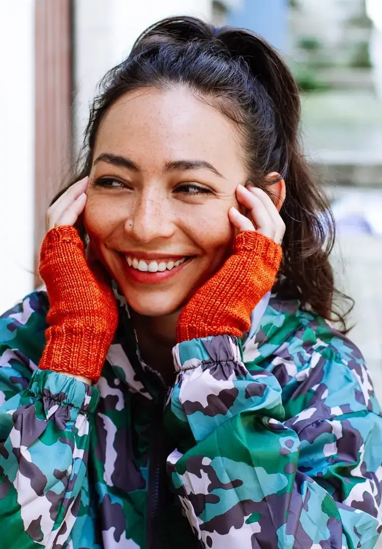 girl wearing orange fingerless gloves